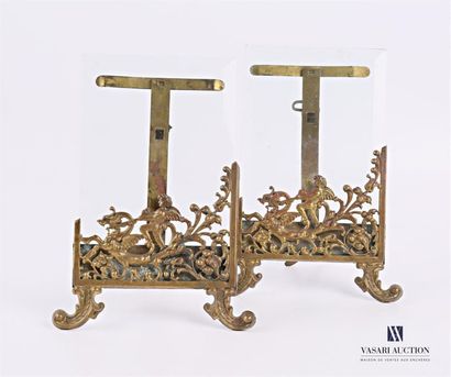 null Pair of frames, the brass frame decorated with a cherub straddling a dragon...