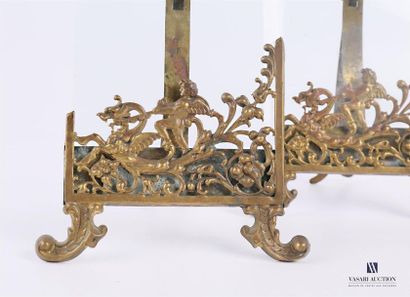null Pair of frames, the brass frame decorated with a cherub straddling a dragon...