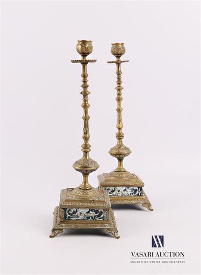 null Pair of bronze candleholders, the turned shaft rests on a dark square base of...