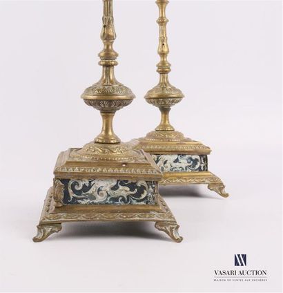 null Pair of bronze candleholders, the turned shaft rests on a dark square base of...