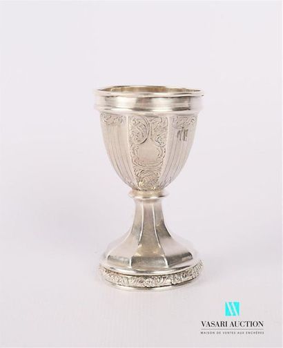 null Silver egg cup resting on a pedestal base with cut-off sides as a reminder of...
