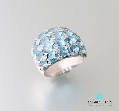 null A 750 thousandths white gold ball ring adorned with twenty oval-cut blue topazes...