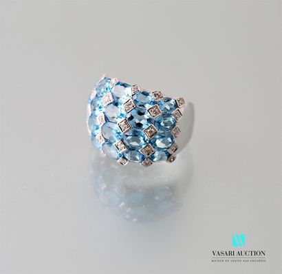 null A 750 thousandths white gold ball ring adorned with twenty oval-cut blue topazes...