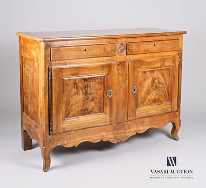 null Moulded and carved natural wood sideboard, it opens on the front by two drawers,...