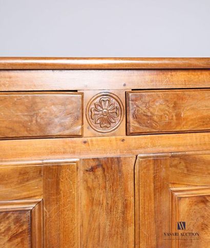 null Moulded and carved natural wood sideboard, it opens on the front by two drawers,...