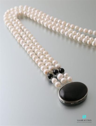 null Three-row necklace of freshwater cut pearls, the agate cabochon clasp, underlined...