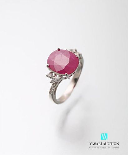 null Ring in white gold 750 thousandths centered of an oval cut ruby calibrating...