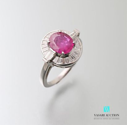 null 750 thousandths white gold ring centered on an oval cut pink ruby calibrating...