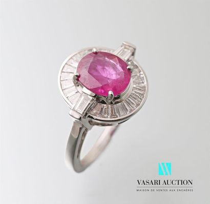 null 750 thousandths white gold ring centered on an oval cut pink ruby calibrating...