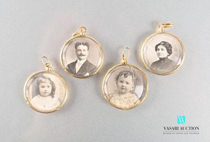 null Four round photo pendants in 750-thousandths gold, with wrapped nets and a plain...