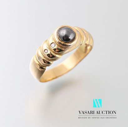 null 750 thousandths yellow gold ring centered on a hematite with three diamonds...