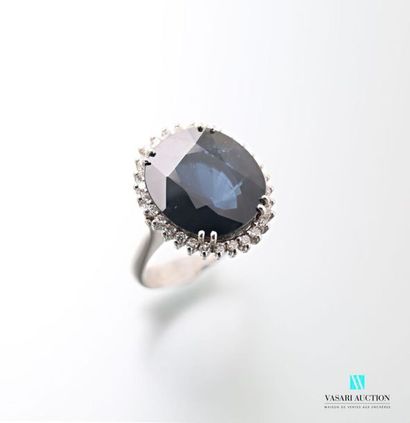 null 750 thousandths white gold ring set with an oval sapphire accompanied by its...