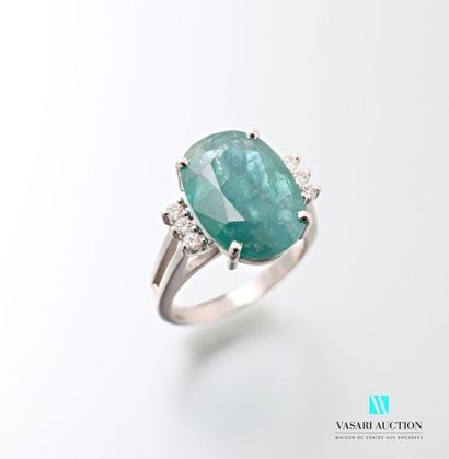 null 875 thousandths white gold ring set with an emerald in its centre and accompanied...