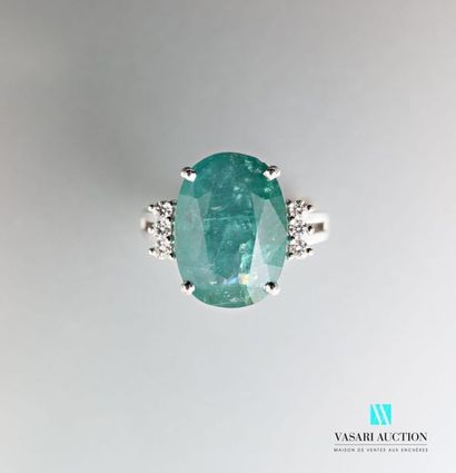null 875 thousandths white gold ring set with an emerald in its centre and accompanied...