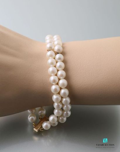 null Two-row bracelet of cultured pearls embellished with two oval gold rings and...