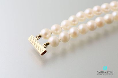 null Two-row bracelet of cultured pearls embellished with two oval gold rings and...