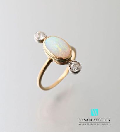 null 750 thousandths yellow gold ring set with a central opal adorned with two old...