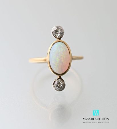 null 750 thousandths yellow gold ring set with a central opal adorned with two old...