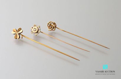 null Three tie pins in 750 thousandths yellow gold: two with circular motifs and...
