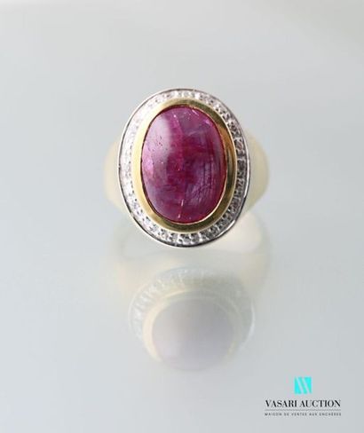 null Gilt vermeil ring centered of a cabochon ruby and framed by a line of white
stones...
