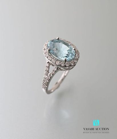 null 750 thousandths gold ring decorated with an oval aquamarine hemmed and shouldered...