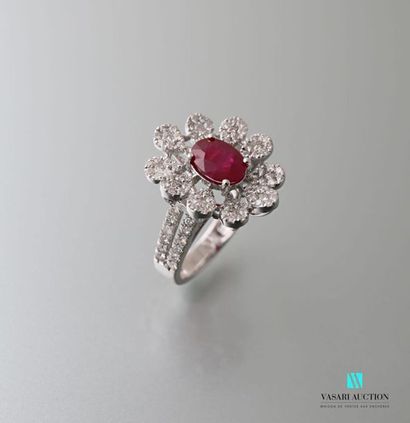 null 750 thousandths gold ring in the shape of a daisy, the heart set with a ruby...