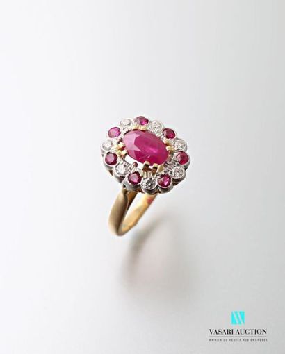 null Two-tone 750 thousandths gold ring set with an oval-shaped unheated ruby calibrating...