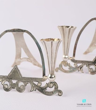 null Pair of silver frame supports decorated with foliage foliage and flanked by...