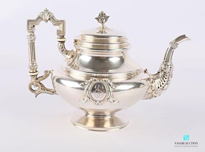 null Silver teapot, the belly decorated with encrypted cartridges, the spout hemmed...