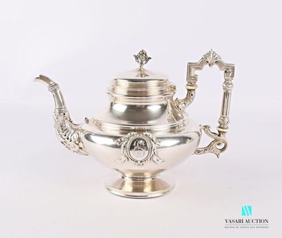 null Silver teapot, the belly decorated with encrypted cartridges, the spout hemmed...
