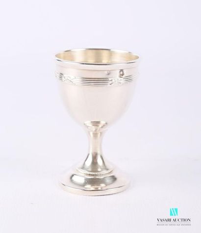 null Silver egg cup resting on a pedestal base, the plain belly hemmed with crossed...