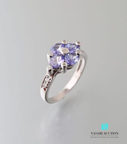 null 750 thousandths white gold ring adorned with four oval-shaped tanzanites interspersed...