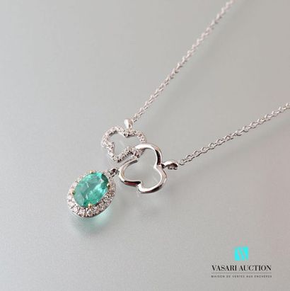 null 750 thousandths white gold necklace adorned with an oval-cut emerald hemmed...