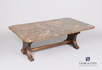 null Coffee table, the top in fossilized stone, it rests on a wooden base joined...
