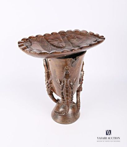 null Carved wooden stool, the curved seat is decorated with fish, it rests on a base...
