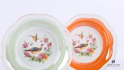 null Pair of porcelain bowls, the basin showing birds and flowers treated in polychrome,...
