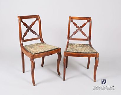 null Pair of chairs in moulded and carved natural wood, the slightly overturned backrest...