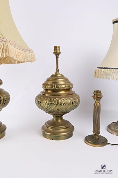 null Set comprising four brass or metal lamp bases, one pair of which is decorated...