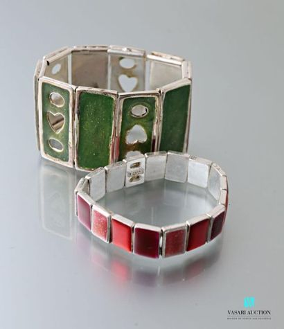 null Two bracelets on stretch cord decorated with enamelled metal plates.