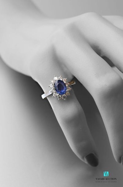 null White gold ring set with an oval-shaped sapphire calibrating approximately 1.70...