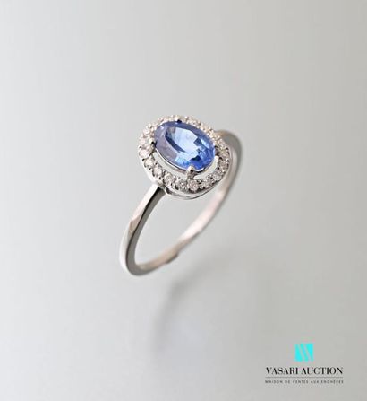 null 750 thousandths white gold ring set with an oval-cut sapphire hemmed with a...
