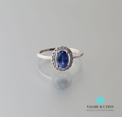 null 750 thousandths white gold ring set with an oval-cut sapphire hemmed with a...