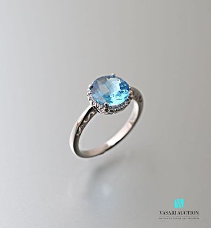 null Round 750 thousandths white gold ring set with a 2.24 carats round topaz surrounded...