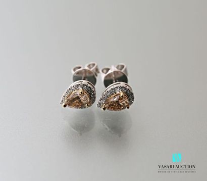 null Pair of pear shaped earrings set with two pear shaped champagne diamonds in...