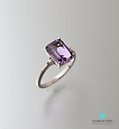 null 750 thousandths white gold ring set with an emerald-cut amethyst of approximately...