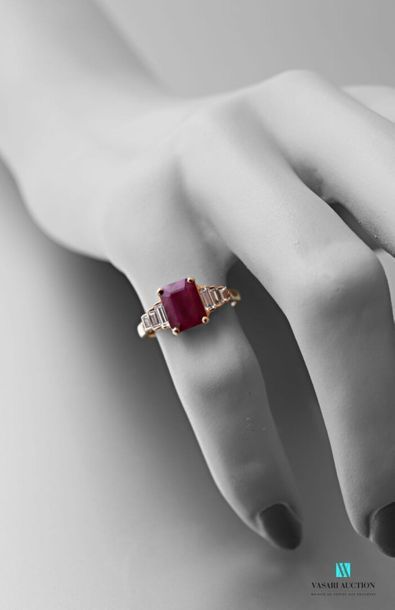 null 750 thousandths pink gold ring set in its centre with a 1.74 carat emerald-cut...