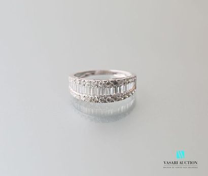 null 750 thousandths white gold rush ring adorned in its center with a line of baguette-cut...
