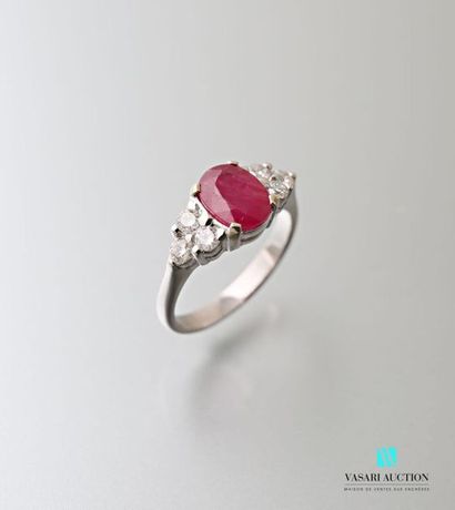 null 750 thousandths white gold ring set in its centre with an oval ruby of approximately...