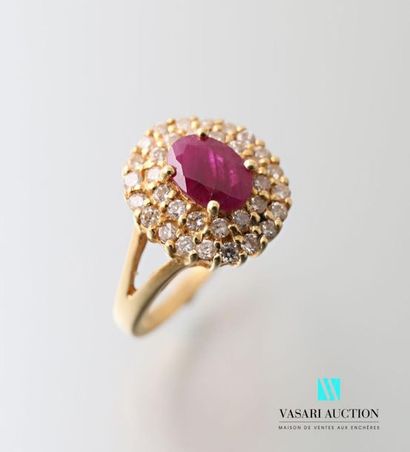null 750 thousandths yellow gold ring with a central oval ruby surrounded by two...
