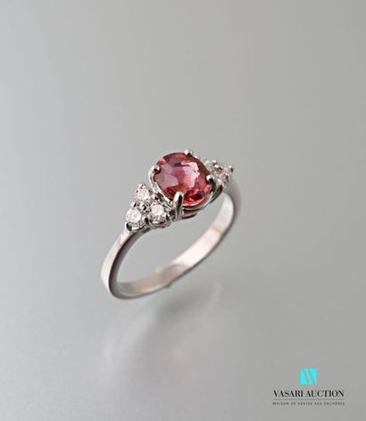 null A 750 thousandths white gold ring set with an oval-shaped peach-coloured tourmaline...